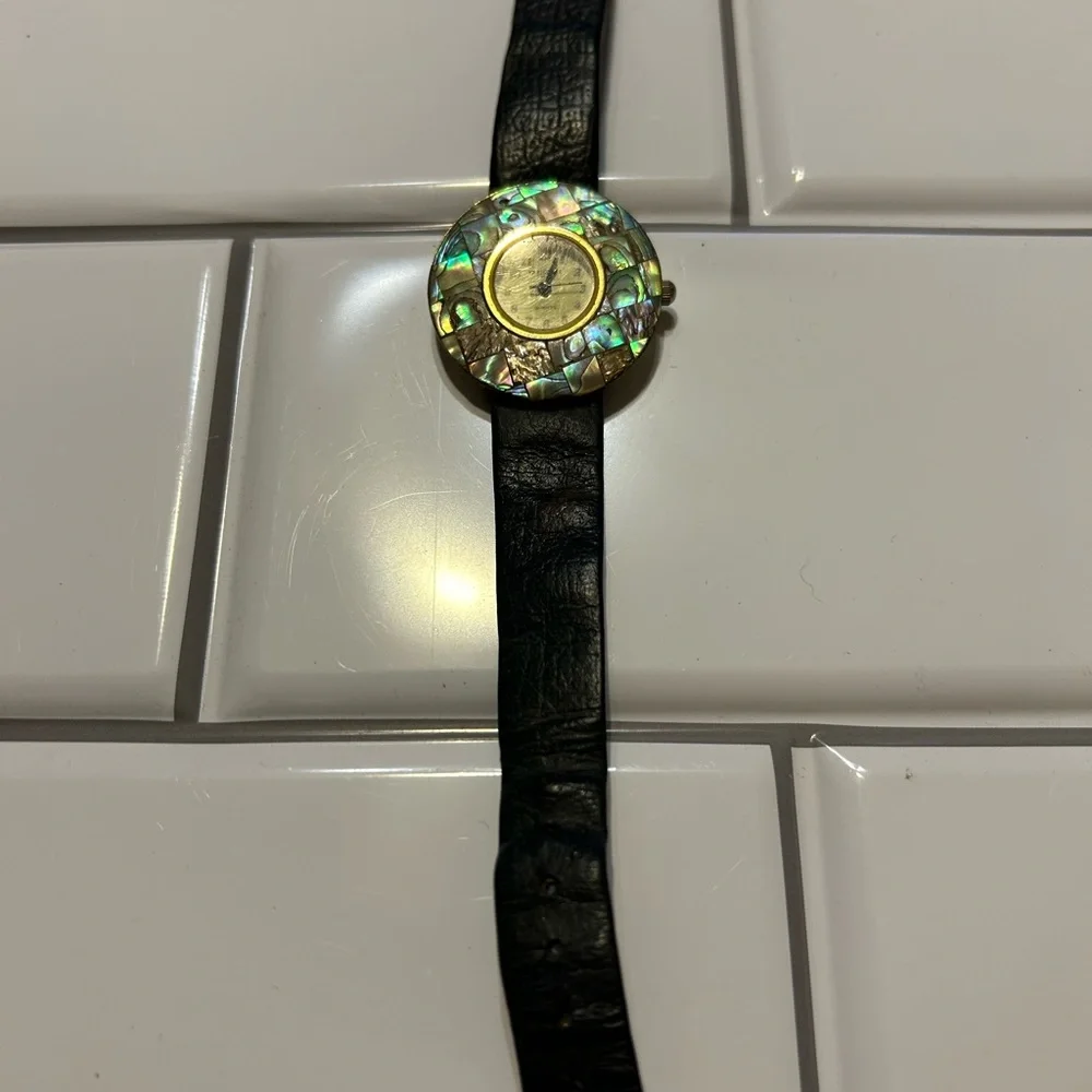 L A Express Mother of Pearl Watch, featuring a round face and a leather band